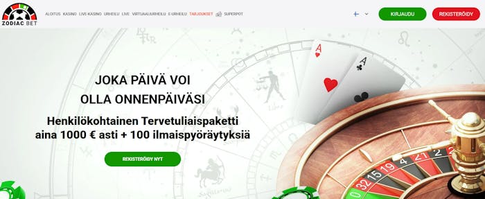Zodiac Bet Casino mainostaa miten jokainen p?iv? voi olla onnenp?iv?si. Taustalla rulettipy?r? ja pelikortit A,A. 